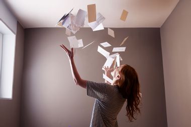 Woman throwing bills in the air