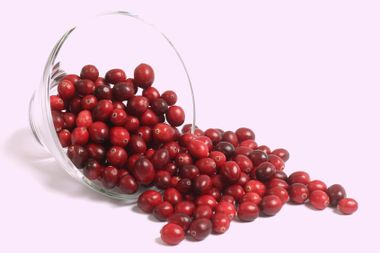 Cranberries spilling out of glass dish