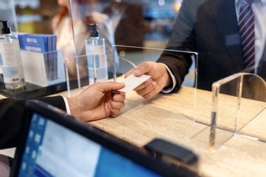 Hotel receptionist giving key card to a guest