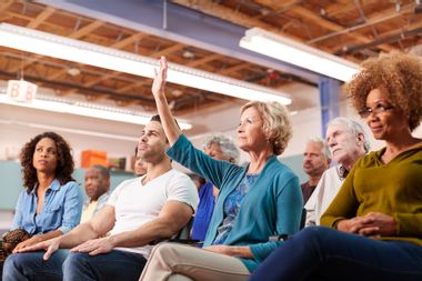 Woman Asking Question At Neighborhood Meeting