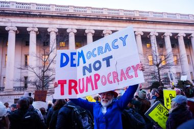 Protester protest holding sign Donald Trump Democracy