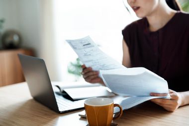 Woman going through bills and receipts