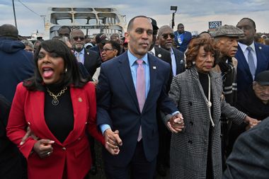 U.S. representatives and civil rights leaders march across the Edmund Pettus Bridge in Selma, Alabama.