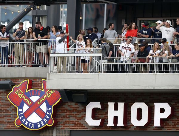 Former Atlanta Braves player Bob Horner (holding the red tomahawk) performs the ceremonial first chop