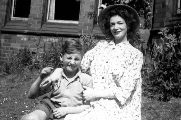 Nine-year-old John Lennon poses for a portrait with his mother Julia