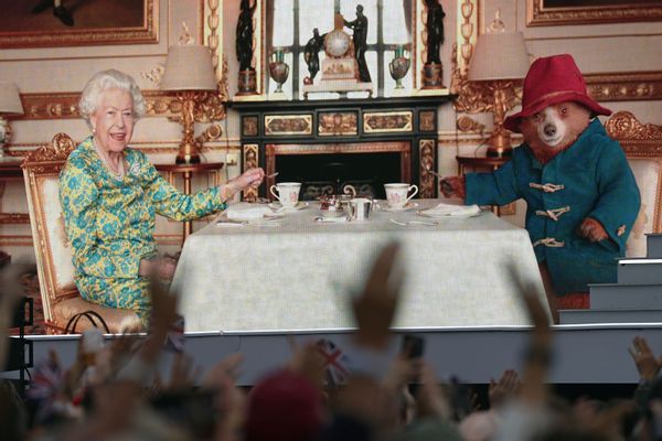Queen Elizabeth II having tea with Paddington Bear