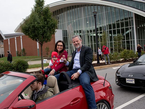 President of Liberty University Jerry Falwell Jr. rides with his wife Becki and a grandchild
