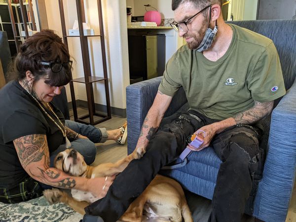 Peer support specialist Donna Norton meets with Ian Dereus and his dog, Lola