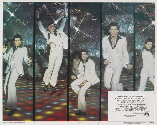 A lobby card for the 1977 US film 'Saturday Night Fever', featuring actor and dancer John Travolta.