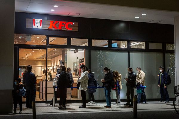 People queue in front of a KFC restaurant on December 23, 2020 in Tokyo, Japan