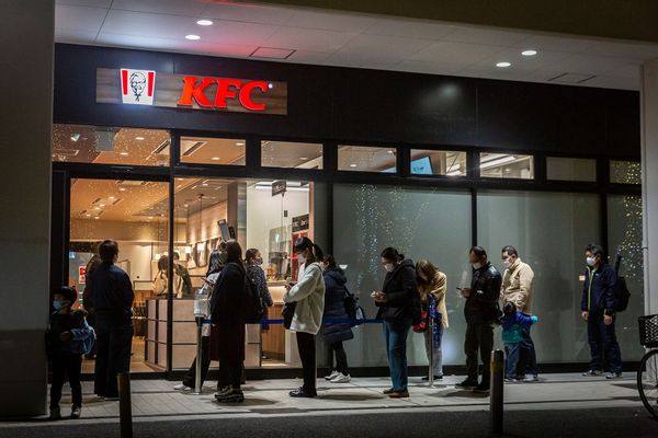 People line up in front of a KFC restaurant in Tokyo on December 23, 2020