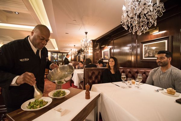 Caesar Salad prepared tableside by Paul Andrew Morton for Gopika Parikh (lt) and Murali Kulathungam (rt) at Rare Steakhouse in Washington, DC on November 27, 2017.