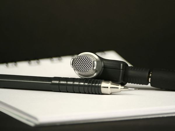 Microphone, pencil and note pad