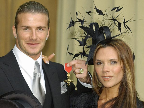 David Beckham stands with his wife, Victoria