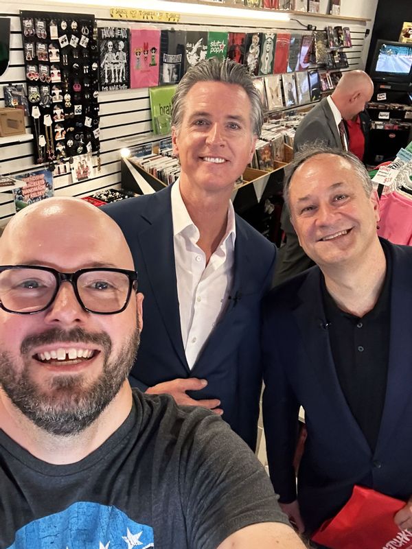 Marc Faletti taking a selfie with Gavin Newsom and Doug Emhoff at Latchkey Records