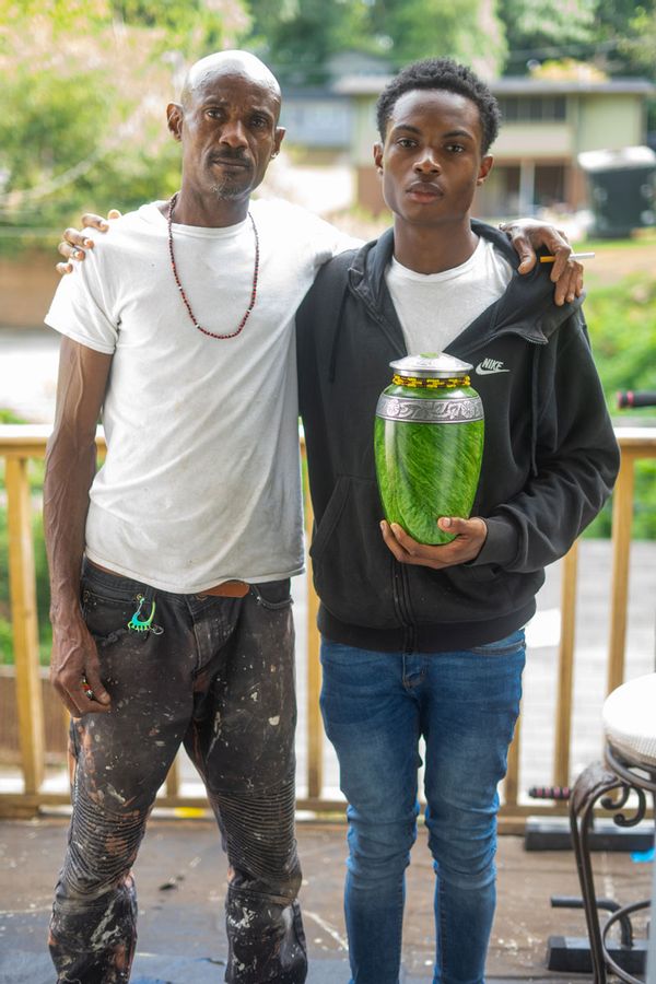 Miller's husband, Alex, and son Christian, with her ashes, at home in Atlanta