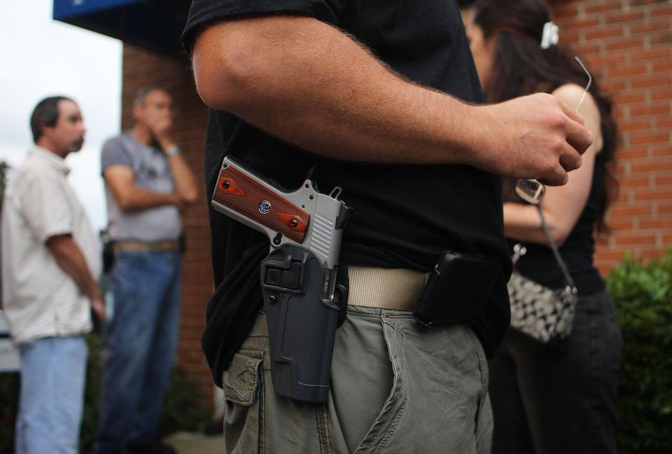 Gun owner with holstered gun at belt