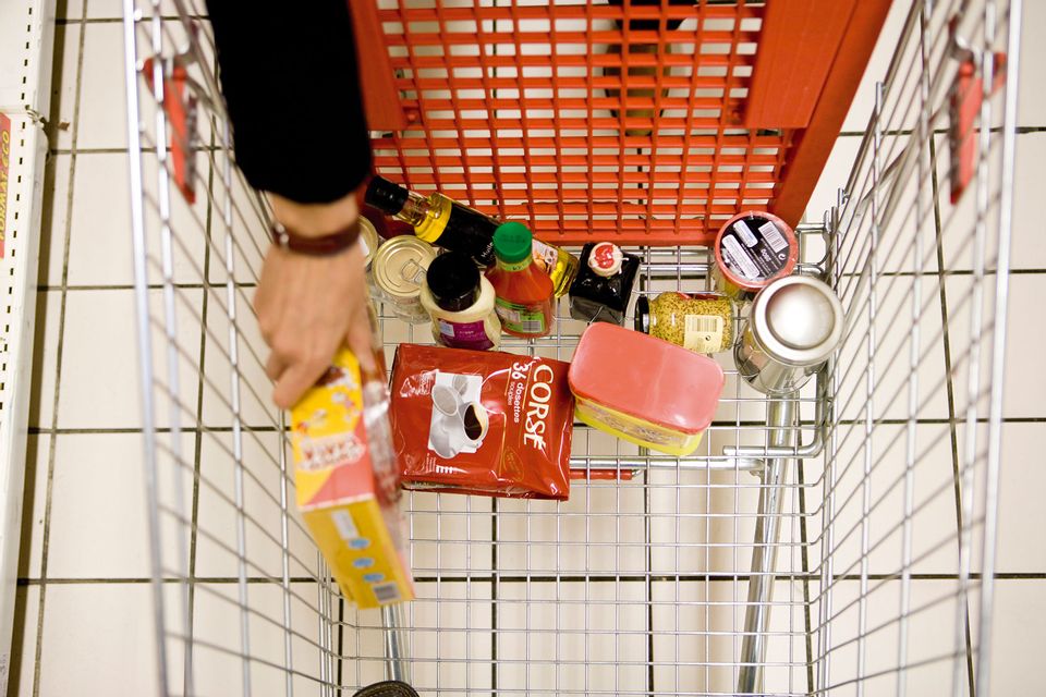 Shopper placing groceries in shopping cart